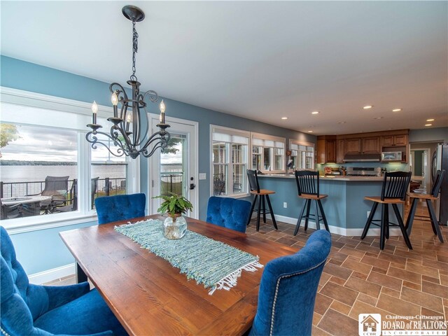 dining space with recessed lighting, baseboards, and a chandelier