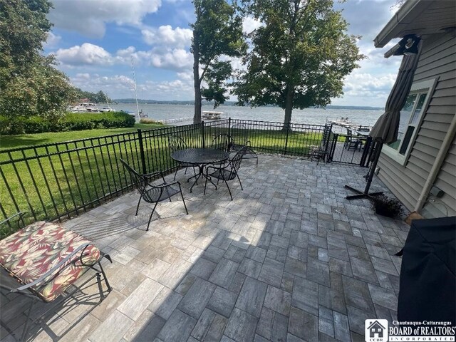 view of patio / terrace with a water view and outdoor dining space