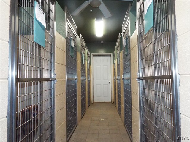 hallway with tile walls and tile patterned floors