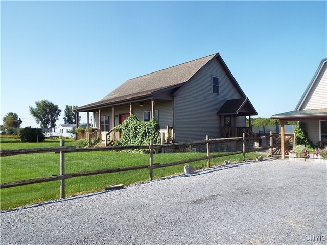 view of front of house featuring a front lawn and covered porch