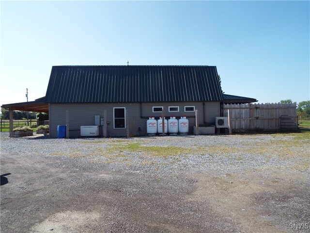 exterior space with central AC unit and a carport