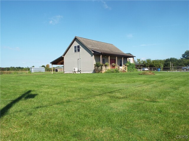 rear view of house featuring a lawn