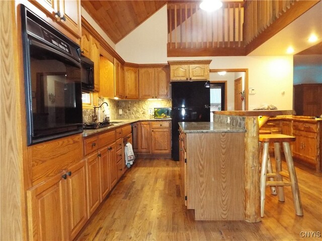 kitchen with light hardwood / wood-style floors, high vaulted ceiling, a breakfast bar, wooden ceiling, and black appliances