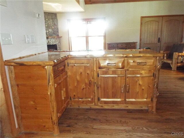 kitchen featuring a fireplace and dark hardwood / wood-style flooring