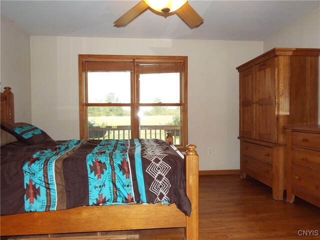 bedroom with ceiling fan and wood-type flooring