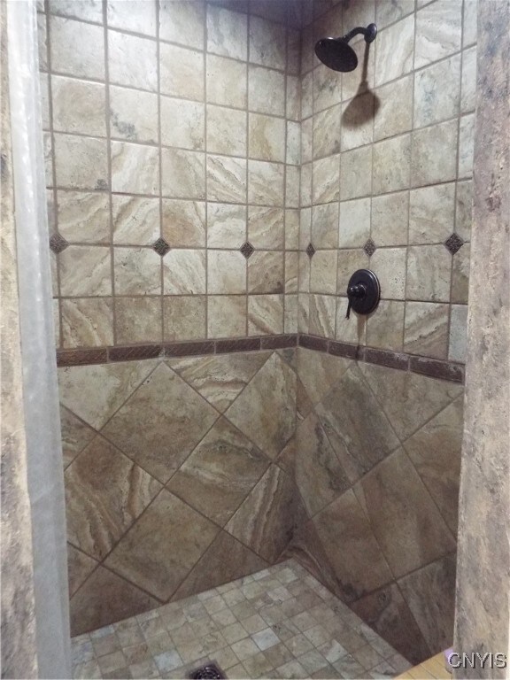 bathroom with a tile shower