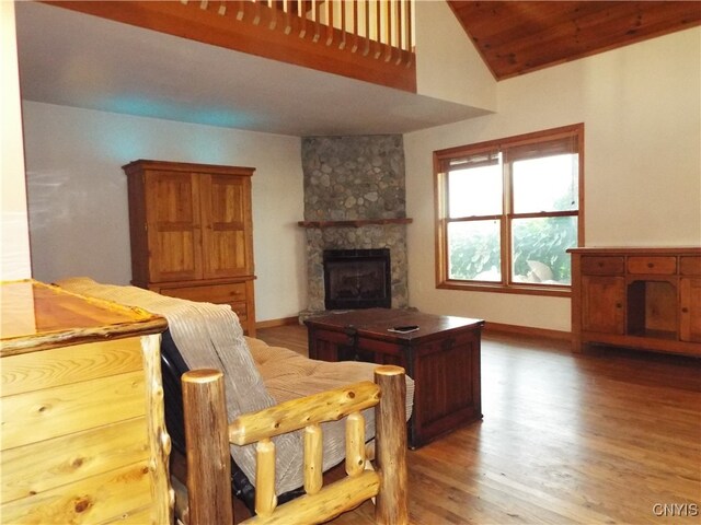 living room with wooden ceiling, a fireplace, high vaulted ceiling, and hardwood / wood-style flooring