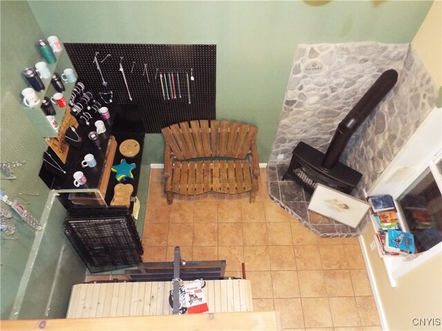 tiled living room featuring a wood stove