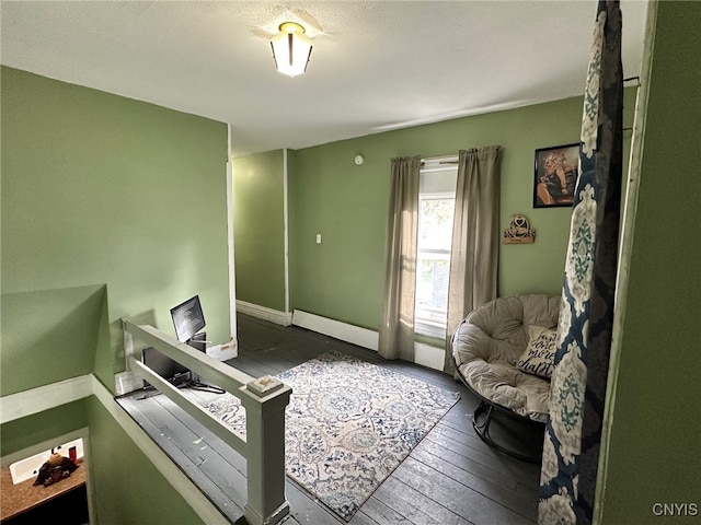 interior space featuring dark hardwood / wood-style flooring and a baseboard heating unit