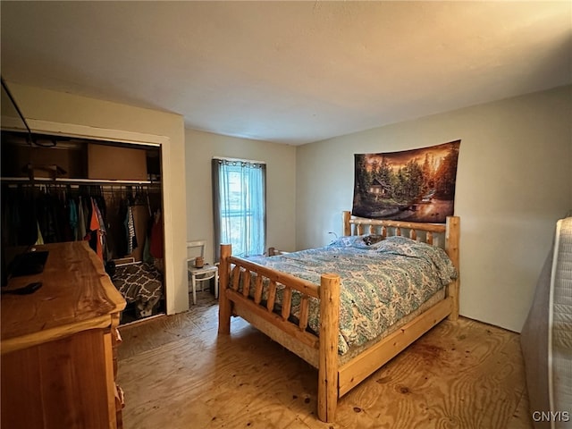 bedroom with wood-type flooring and a closet