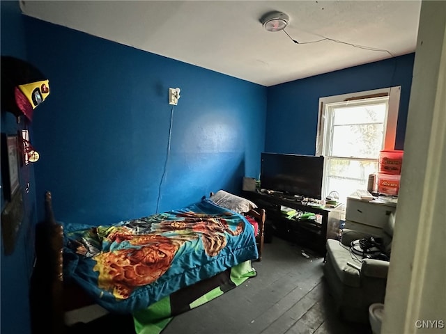 bedroom with hardwood / wood-style floors