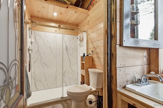 bathroom featuring walk in shower, wooden walls, toilet, and sink