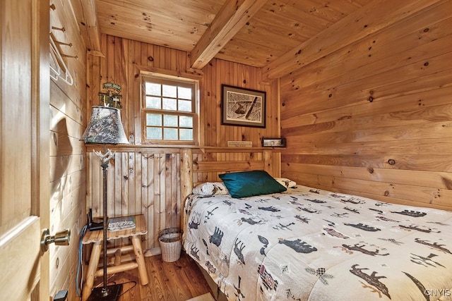 bedroom with wood ceiling, wooden walls, hardwood / wood-style floors, and beamed ceiling