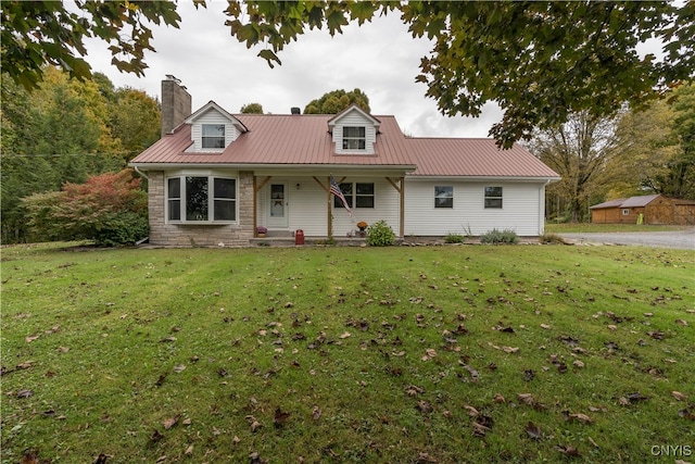 cape cod house with a front yard and a porch