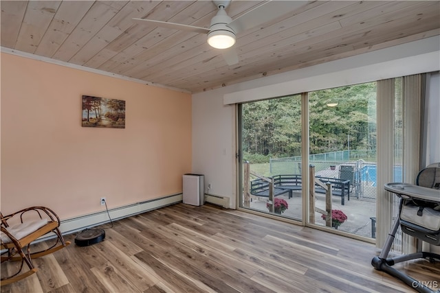 interior space featuring light wood-type flooring, ornamental molding, a baseboard heating unit, and wooden ceiling