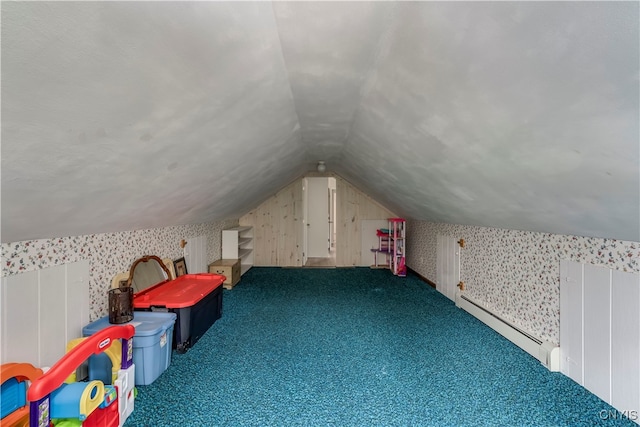 additional living space featuring dark colored carpet, lofted ceiling, and baseboard heating