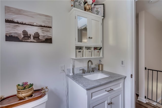 bathroom featuring hardwood / wood-style floors, vanity, and toilet