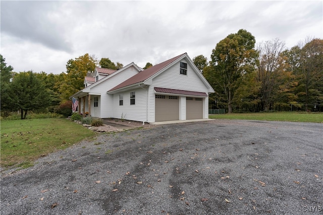 view of property exterior featuring a lawn and a garage