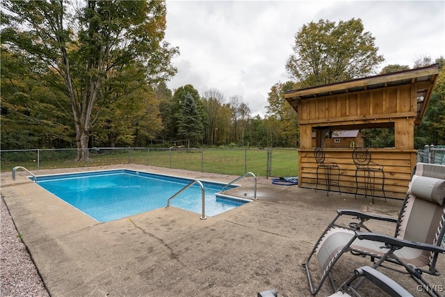 view of swimming pool with a patio area