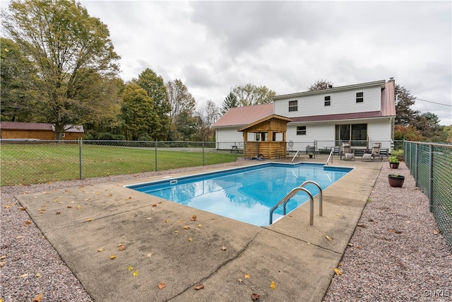 view of swimming pool featuring a lawn and a patio area