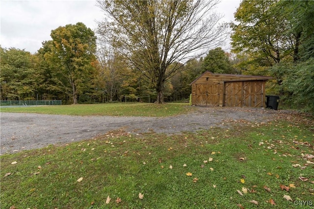 view of yard with an outdoor structure and a storage unit