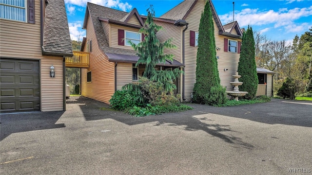 view of side of home with a garage