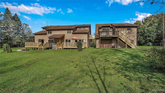 back of house featuring a garage, a wooden deck, and a yard