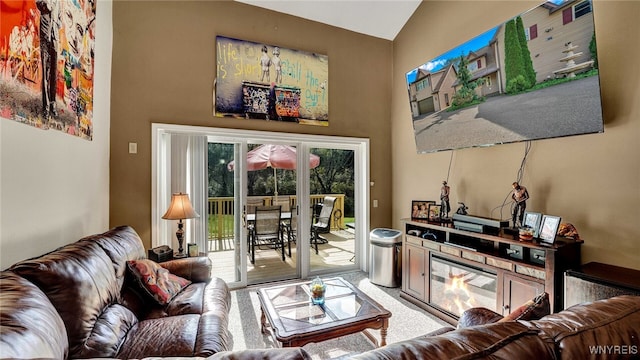 living room with carpet floors and high vaulted ceiling