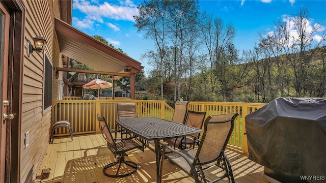 wooden terrace featuring area for grilling