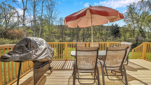 wooden deck with a grill