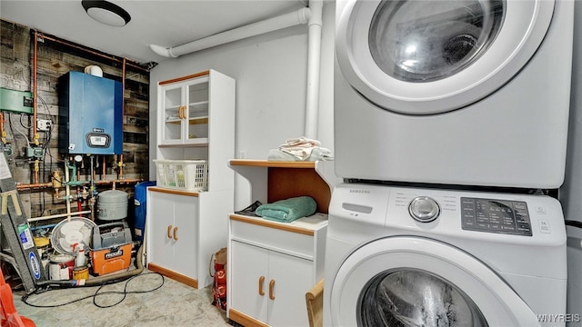 laundry room featuring water heater and stacked washing maching and dryer