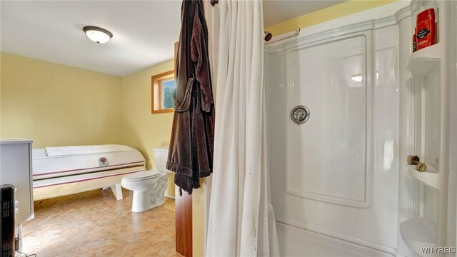 bathroom with toilet and curtained shower