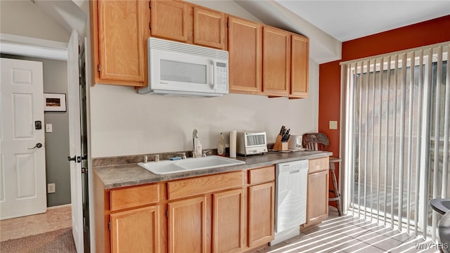 kitchen featuring sink, white appliances, and light brown cabinets