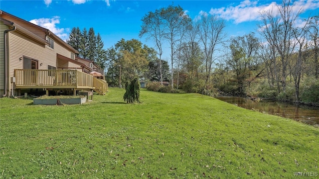 view of yard featuring a deck with water view