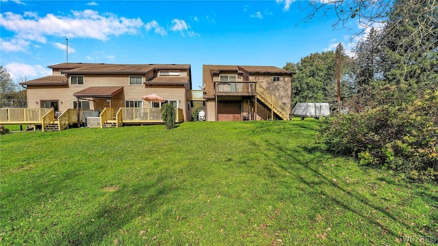 back of house with a deck and a lawn