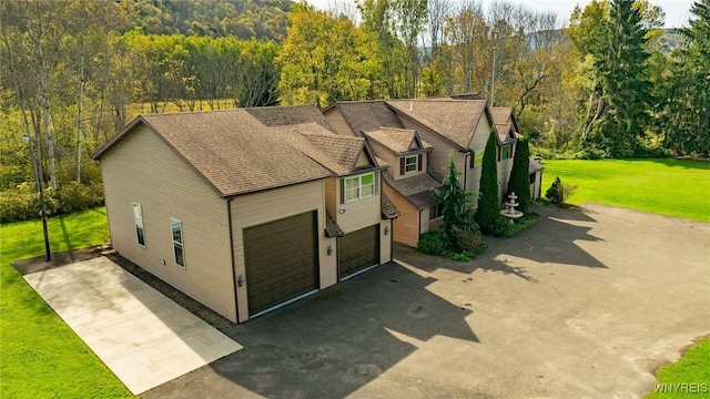 view of front of property featuring a garage and a front lawn