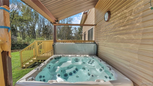 wooden deck featuring a covered hot tub