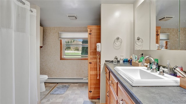 bathroom with vanity, a baseboard radiator, and toilet