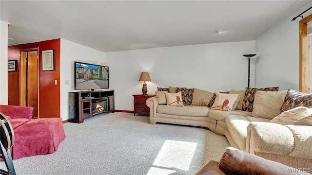 carpeted living room with a fireplace