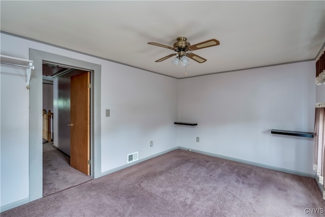 carpeted spare room with ceiling fan