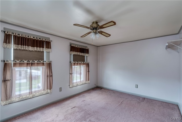 spare room featuring carpet and ceiling fan