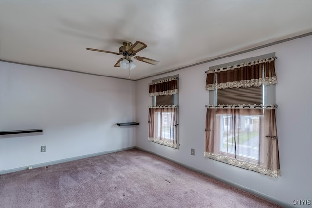 spare room featuring ceiling fan and light colored carpet