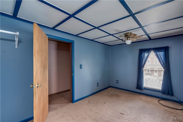 unfurnished bedroom with light carpet, ceiling fan, and coffered ceiling