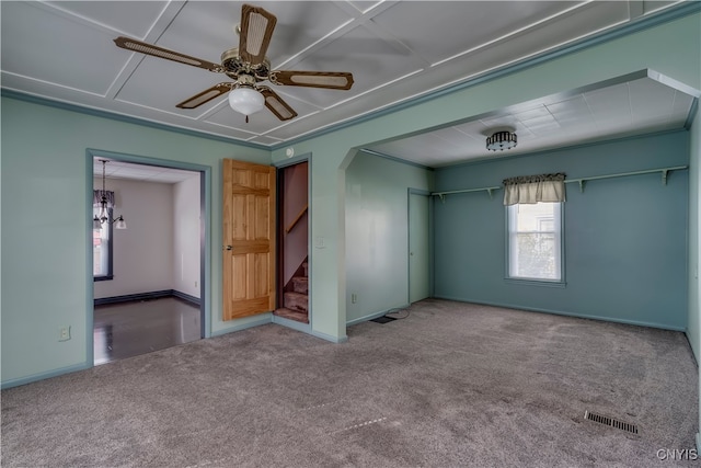 empty room with ceiling fan, carpet flooring, and crown molding