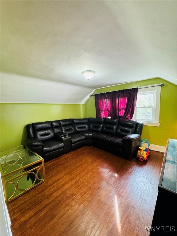 living room with hardwood / wood-style floors and vaulted ceiling