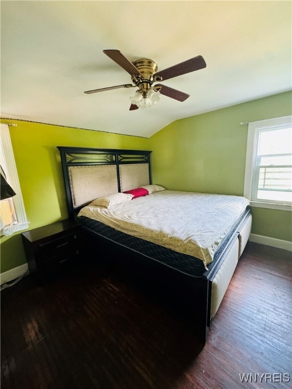 bedroom with vaulted ceiling, dark hardwood / wood-style floors, and ceiling fan