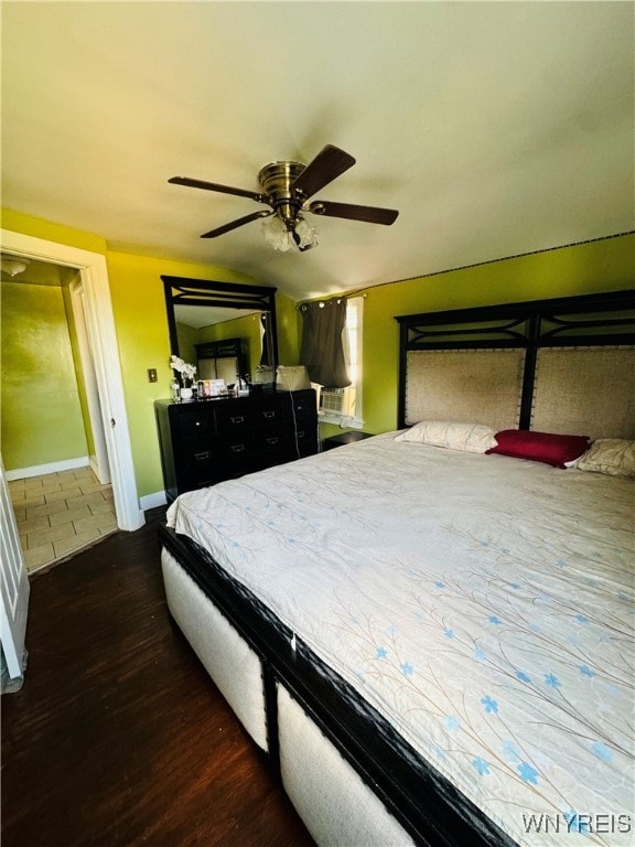 bedroom with ceiling fan and dark wood-type flooring