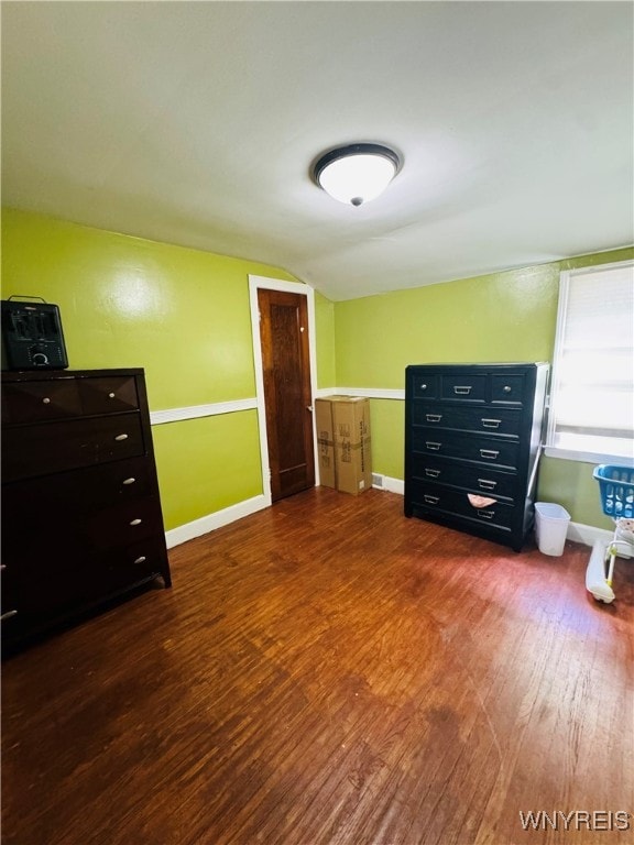 bedroom featuring wood-type flooring and vaulted ceiling