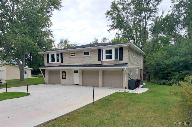 front facade featuring a garage and a front lawn