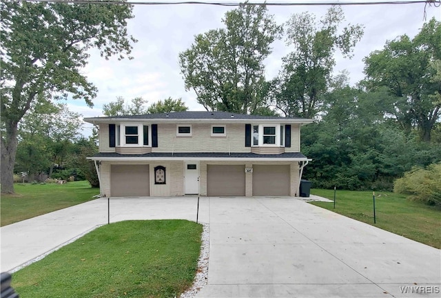 view of front of home with a front yard and a garage